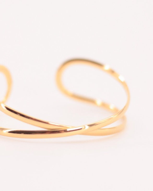 Brazalete ajustable dos bandas cruzadas acero baño oro 18K Exes