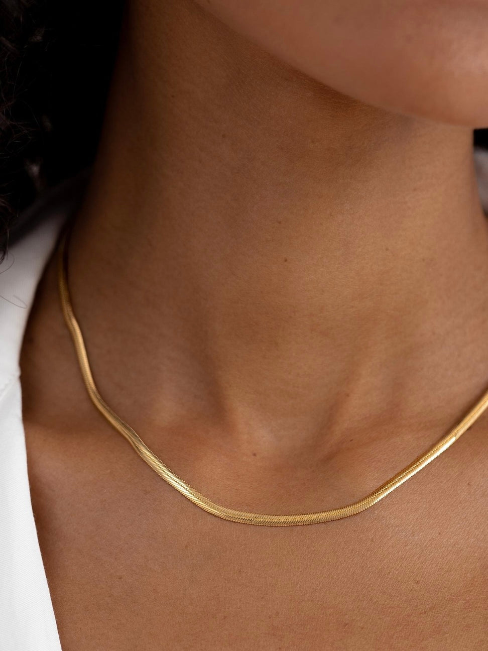 Cadena plana 3mm en acero baño oro 18K Lisa