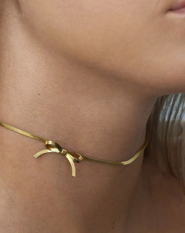 Gargantilla estilo cadena plana con lazada en acero baño oro 18K