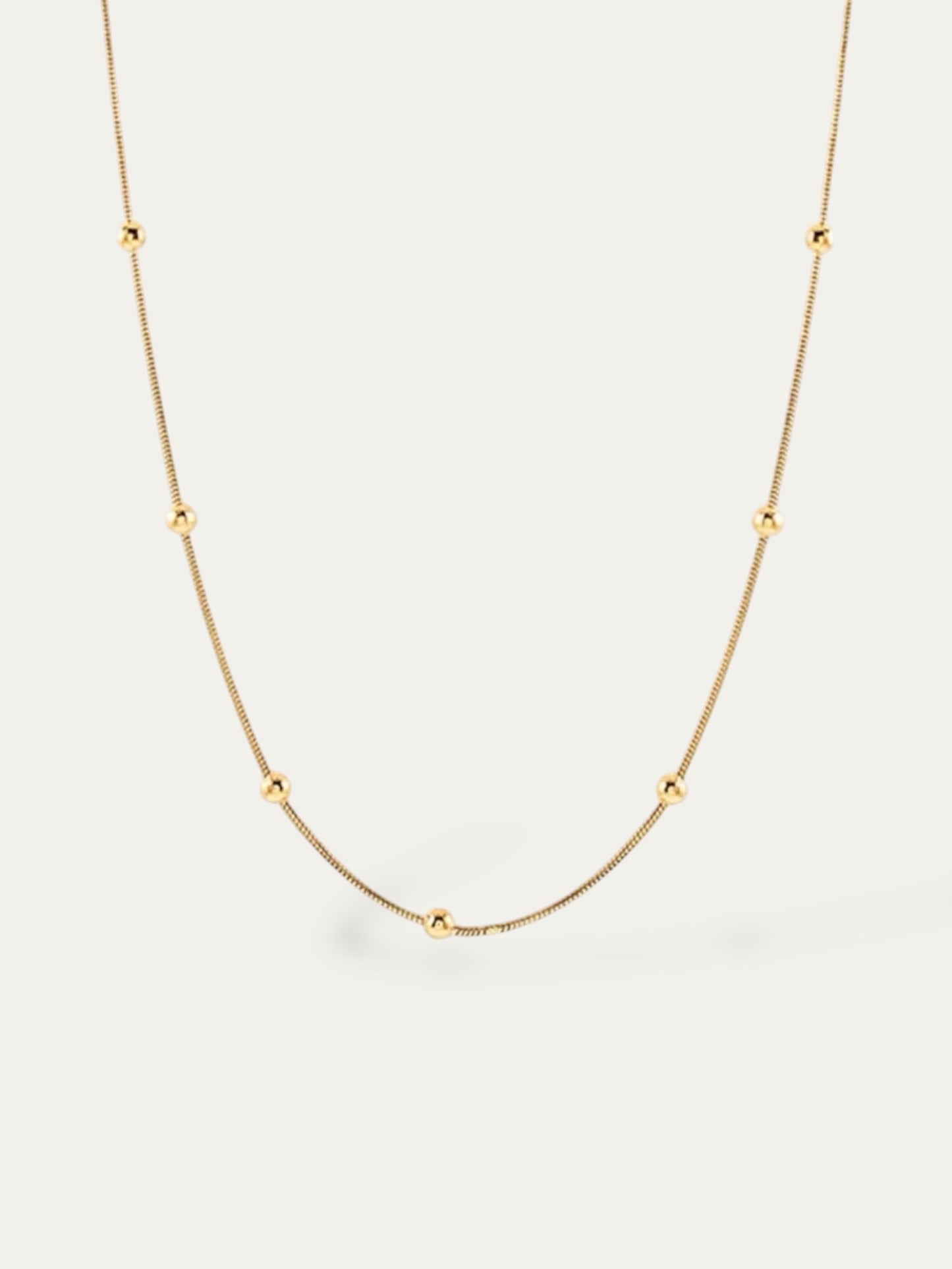 Cadena estilo serpiente con bolitas en acero baño oro 18K Phiton